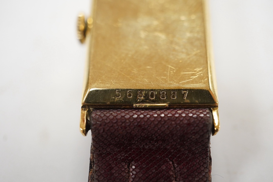 A gentleman's 14k gold Longines manual wind wrist watch, with rectangular dial, baton numerals and subsidiary seconds, case diameter 20mm, on a later associated strap. Condition - fair